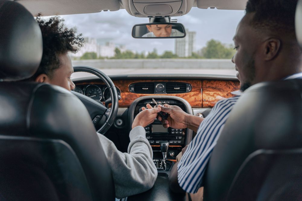 Driving instructor and learner inside a right-hand drive car